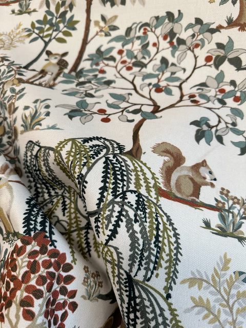 Woodland animal and tree motif on Enchanted Forest fabric in eucalyptus green