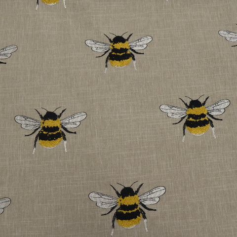 Embroidered bee fabric Busy Bee Linen close-up showing bee motif on linen look ground